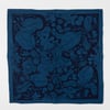 A square blue bandana with a dark floral and leafy swirl pattern and a solid border.
