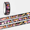 A roll of black washi tape printed with colorful mushroom and fungi illustrations, shown with several unrolled strips of the same pattern.