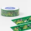 A roll of green washi tape printed with cartoon frogs, lily pads, and dragonflies in green, purple, and black.