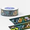 A roll of washi tape with a pigeon-and-city illustration and a white top label printed with the Meg Hunt logo and "meghunt.com".