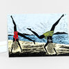 A folded greeting card with an illustration of two upside-down women doing handstands on a beach, each wearing a patterned swimsuit and long flowing hair.