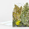 A folded greeting card with a botanical illustration of a yellow frog sitting among layered green and gold fern fronds, with no visible text.