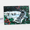 A folded greeting card with a colorful winter bird illustration showing a bird on snowy ground with red berries, green leaves, and a dark sky.