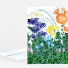 A folded greeting card with a colorful botanical illustration of flowers and foliage on the front and a blank white envelope partially visible behind it.