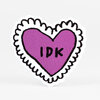 A heart-shaped sticker with a purple center outlined in black and a scalloped black border, with the text "IDK" in the middle.