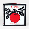A hardcover book titled "APPLE" by Nikki McClure with a red apple and black leaves on the cover.
