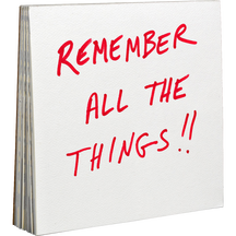 A stack of square white paper pads, with the front pad printed in red handwritten-style text reading "REMEMBER ALL THE THINGS!!"