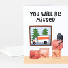A folded greeting card with the hand-lettered text "YOU WILL BE MISSED" and an illustration of a moving truck, stacked labeled boxes, and a cat sitting on top of one box.