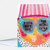 A greeting card featuring a colorful illustrated face with teal glasses, striped pink hair, and the text "BIRTH-DAYS ARE" in one lens and "FOR BEING EXTRA" in the other.