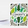 A folded greeting card with a colorful leaf-and-branch pattern and the word "CONGRATS" printed across the center.