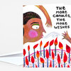 A folded greeting card with an illustrated face surrounded by many lit candles and the text "THE MORE CANDLES, THE MORE WISHES" on the front.