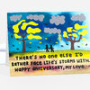 A folded greeting card with a colorful illustration of two small black figures holding hands between two trees under clouds and a lightning bolt, with the text "THERE'S NO ONE ELSE I'D RATHER FACE LIFE'S STORMS WITH. HAPPY ANNIVERSARY, MY LOVE."