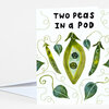 A folded greeting card with the text "TWO PEAS IN A POD" and an illustrated pea pod with two smiling peas and curling vine and pea pod motifs.