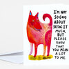 A folded greeting card with a colorful stylized dog illustration and the text "I'M NOT SO GOOD ABOUT SAYING IT MUCH, BUT PLEASE KNOW THAT YOU MEAN A LOT TO ME."