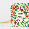 A folded greeting card with a colorful vegetable pattern and the text "YOU'RE SUCH A BADASS MOM" on the front.