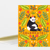 A folded greeting card with a bright orange front featuring a seated panda wearing a party hat, surrounded by leaves, flowers, and stars, with the word "CELEBRATE!" at the bottom.