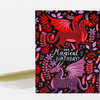 A greeting card with a black background, red and purple dragons and leaves, and the text "Have a Magical Birthday!" on the front.