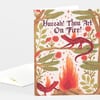 A folded greeting card with the text "Huzzah! Thou Art On Fire!" and an illustrated scene of red spotted lizards, flames, leaves, flowers, and branches.