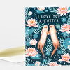 A greeting card with the text "I LOVE YOU A L'OTTER" and an illustration of two otters holding paws among pink water lilies and green lily pads on a dark background.