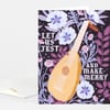 A greeting card with a floral pattern and a stringed instrument illustration, featuring the text “LET US JEST AND MAKE MERRY.”