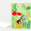 A folded greeting card with a green cover featuring the words "MANY THANKS" and an illustration of a hare sitting on a tree stump among flowers, leaves, a bird, and a small nest with eggs.