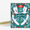 A folded greeting card featuring four white swans flying in a floral pattern around the words "Sending Love."