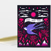 A greeting card with a black cover featuring a purple bird, pink flowers and foliage, stars, clouds, mountains, and the text "YOU GOT THIS" on a white banner.