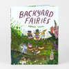 A hardcover book titled "BACKYARD FAIRIES" by Phoebe Wahl with an illustrated cover showing small fairies and woodland plants.