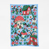 A rectangular knitted blanket with a light blue background and a colorful illustrated pattern of mushrooms, flowers, gnomes, and small cottages.