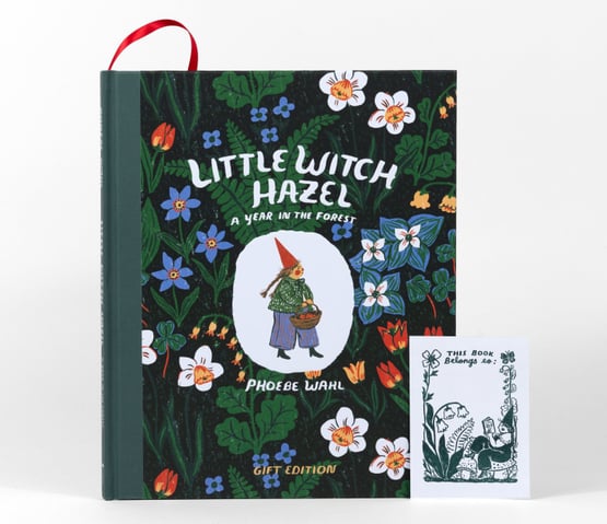 A hardcover book titled "Little Witch Hazel: A Year in the Forest" by Phoebe Wahl, with a floral cover illustration and a separate bookmark or bookplate insert that reads "This Book Belongs to:".
