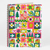 A spiral-bound notebook with a colorful folk quilt-style cover featuring small houses, birds, butterflies, flowers, trees, and geometric patchwork squares.
