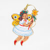A painted fairy ornament with yellow butterfly wings, a white dress, red shoes, and a gold hanging loop, holding a star-topped wand.