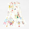 A white child-sized cape with a ruffled collar and a colorful circus-themed print featuring performers, a tent, and animals.