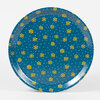 A small round teal tray with a raised rim, covered in scattered yellow Star of David motifs and tiny light-blue dots.