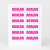 A sheet of hot pink labels or stickers printed repeatedly with the word "ANALOG" in bold retro-style lettering, with one label shown upside down.
