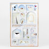 A framed mixed-media collage print with a pale blue and white grid of small illustrated panels, including an exclamation mark, eye, tube, dice, pyramid, pointing hand, giraffe head, arch, envelope, pen, Leaning Tower, peacock feather, and decorative cursive alphabet strip.