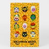 A bright orange sheet printed with twelve colorful Halloween mask illustrations arranged in a grid, with the text "HALLOWEEN MASKS" and the name "Ellen Surrey" at the bottom.