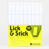 A package of Portland Stamp Company "Lick & Stick" stamp paper with a grid of perforated white sheets and a bright yellow label reading "Lick & Stick," "10 sheets," and "STAMP SIZE 1" x 2.5"."