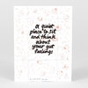 A white printed art card or print with delicate floral line drawings and bold black text reading "a quiet place to sit and think about your gut feelings," with a small handwritten signature and edition number at the bottom.