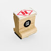 A small wooden self-inking stamp with a clear cap showing a red "O.K." inside a diamond shape and a black circular logo with a white "P" on the side.