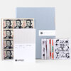 An art stamp box set with a pale blue folder, a white booklet labeled "The Artist Series No. 1 - 10," and several sheets of illustrated postage stamps featuring black-and-white drawings and portrait stamps.