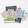 An assortment of illustrated stamp sheets and small printed stamp-card panels arranged in a fan shape, featuring colorful designs such as flowers, birds, lips, abstract patterns, and handwritten-style words.