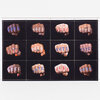 A rectangular print showing twelve clenched fists arranged in a grid, each fist stamped with the word "VOTE" in different colors.