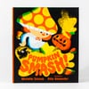 A children's book titled "PUMPKIN SMASH!" with a black cover featuring a smiling character in a large orange-and-yellow polka-dot hat, a pumpkin face, and the names Michelle Schaub and Rilla Alexander printed on the cover.