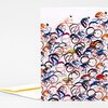 A folded greeting card with a front cover covered in a repeating hand-drawn pattern of cyclists and bicycles in blue, red, orange, black, and pink.
