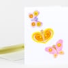 A folded greeting card with three colorful butterfly illustrations in pink, yellow, and lavender.
