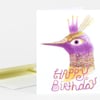 A folded greeting card shows a purple crowned bird illustration with the text "HAPPY Birthday" on the front.