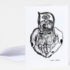 A folded greeting card with a black-and-white illustration of a figure held in two large hands and the printed signature text "nonyelum AYEOLA" at the bottom.