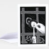 A greeting card with an illustrated black-and-white cover showing a hand lighting a candle by a window at night.