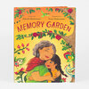 A hardcover book titled "MEMORY GARDEN" with cover text "Written by Zohreh Ghahremani" and "Illustrated by Susie Ghahremani," showing an older woman and a young girl hugging among colorful flowers and leafy branches.
